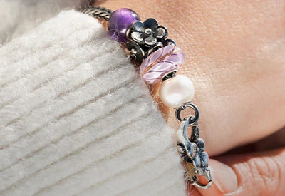 Flower themed beads and clasp on a Trollbeads bracelet